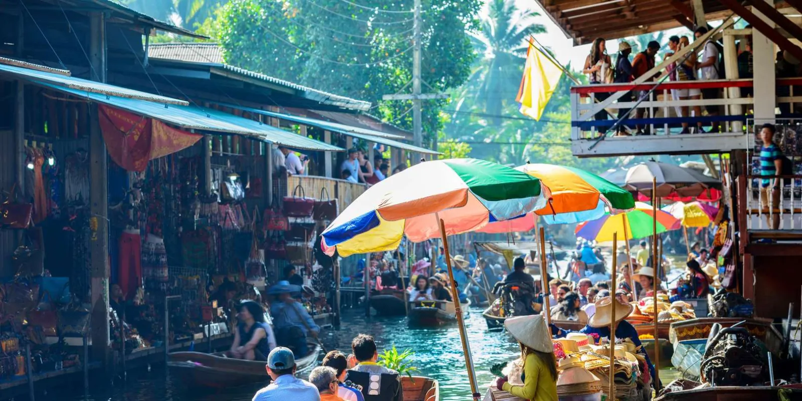 Floating-market canal with boats and umbrellas