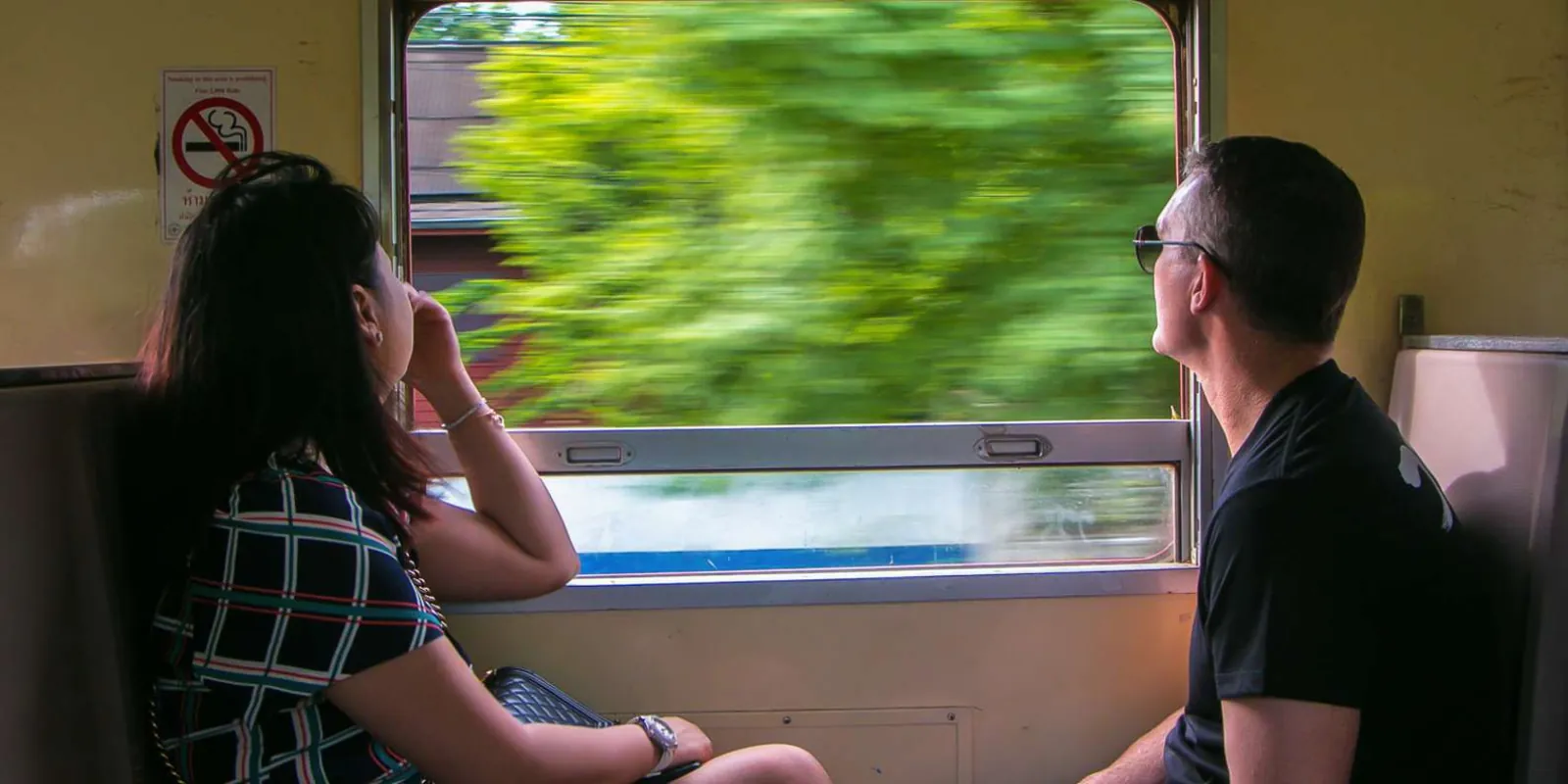Passengers looking out from a local train
