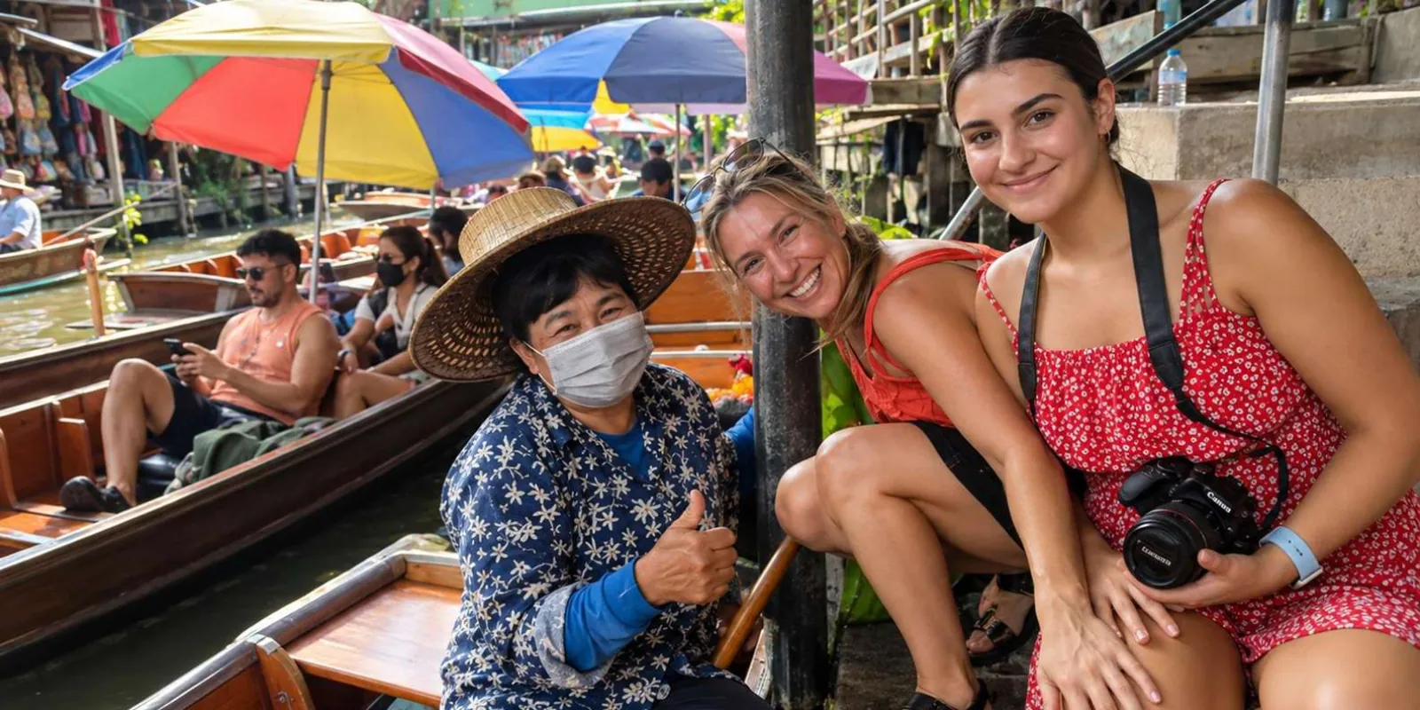 Travelers in a boat beneath market umbrellas