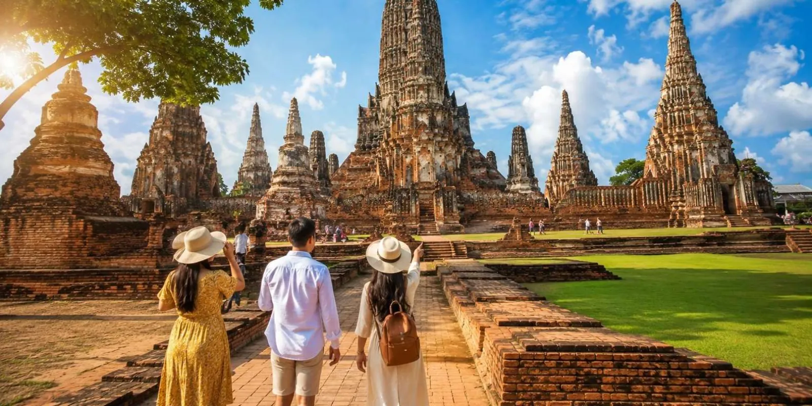 Visitors walking toward Ayutthaya temple towers