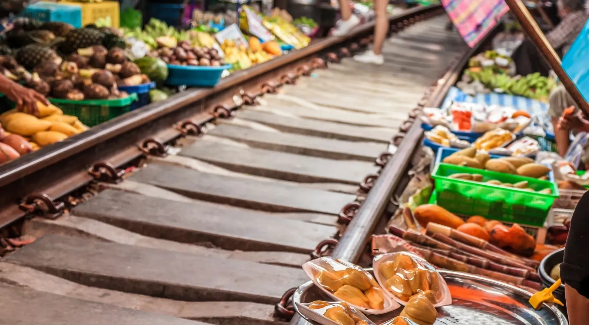 Produce stalls beside the railway tracks
